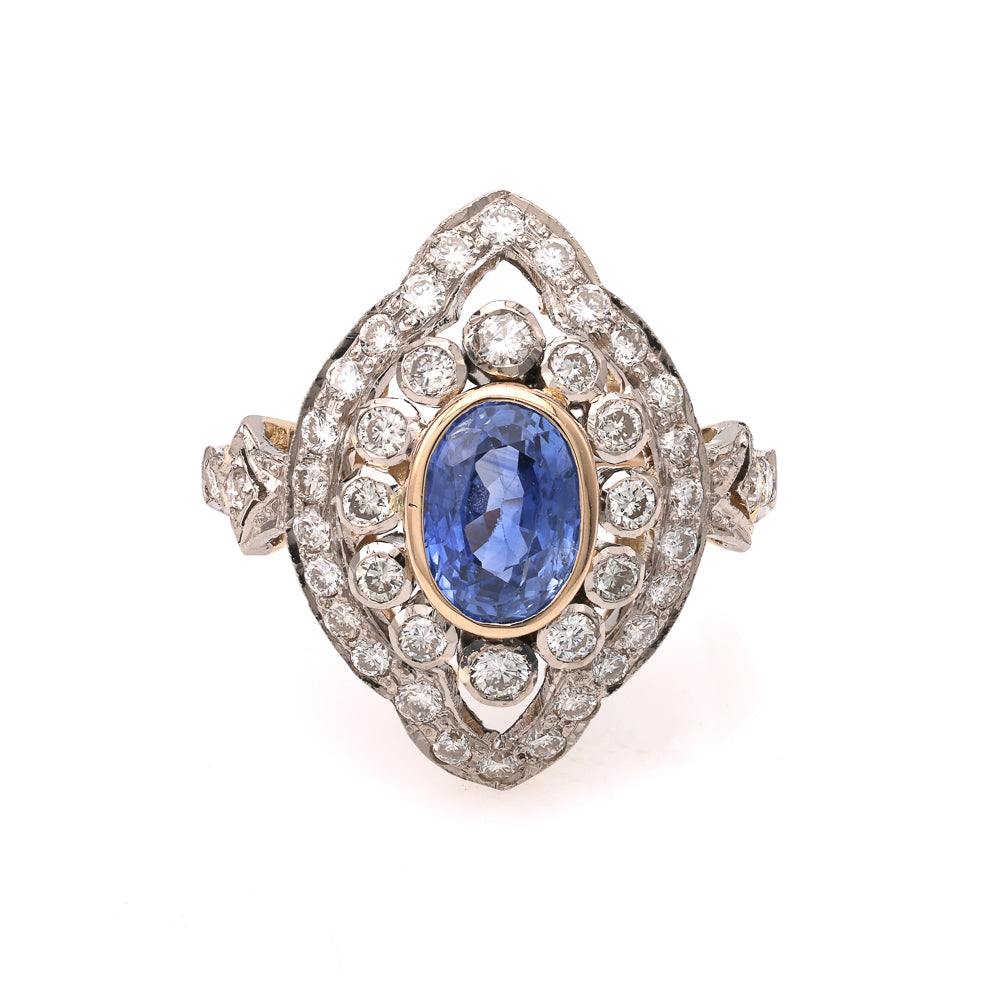 Oval blue sapphire ring with diamond halo.