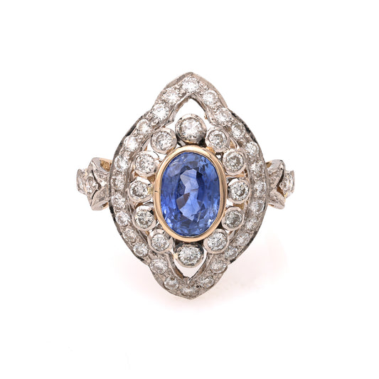 Oval blue sapphire ring with diamond halo.