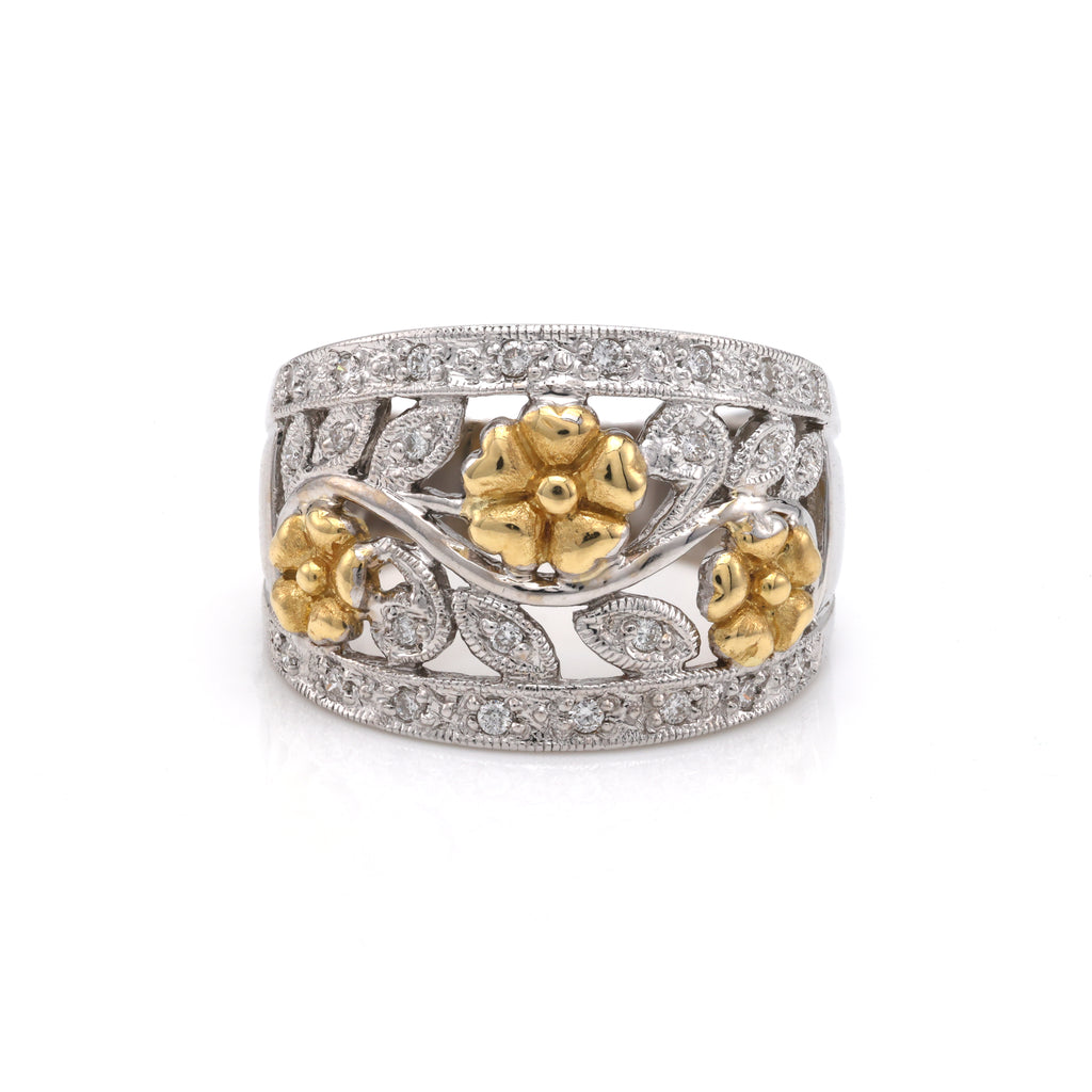 Gold floral diamond-accented white band ring.