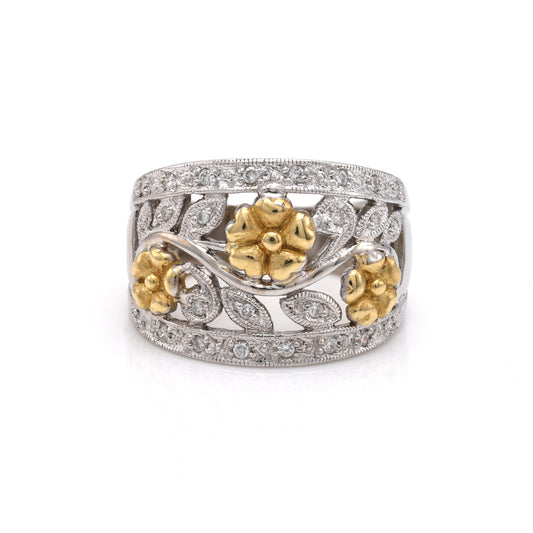 Gold floral diamond-accented white band ring.