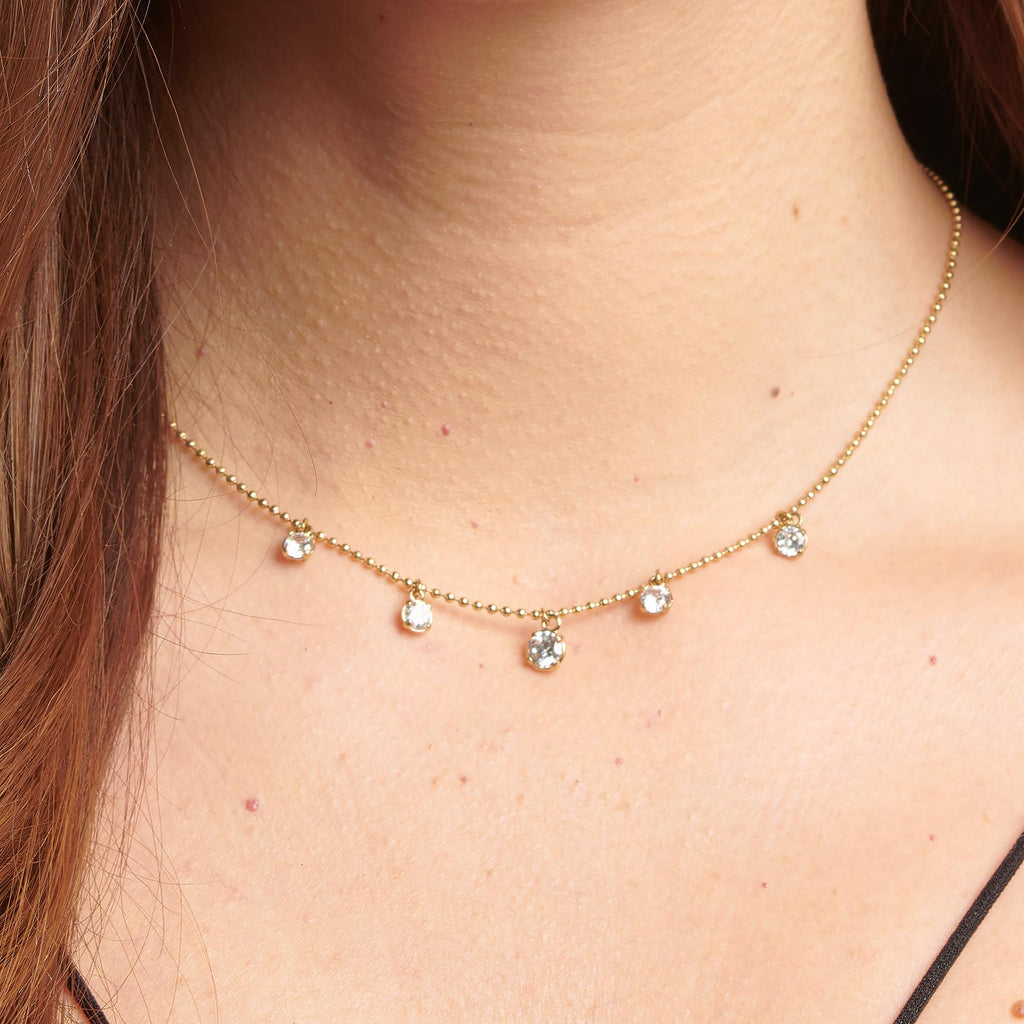 Gold-tone necklace with simulated diamond pendants.