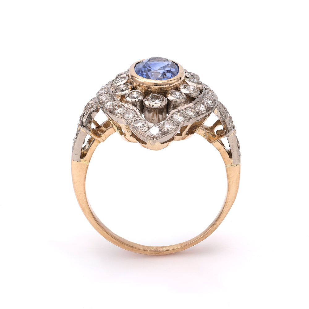 Oval blue sapphire ring with diamond accents.