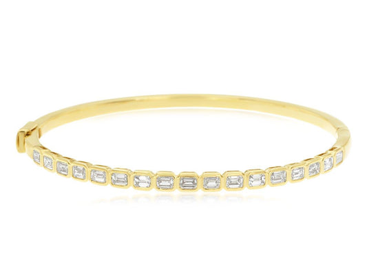 Yellow gold bangle with emerald-cut diamonds.