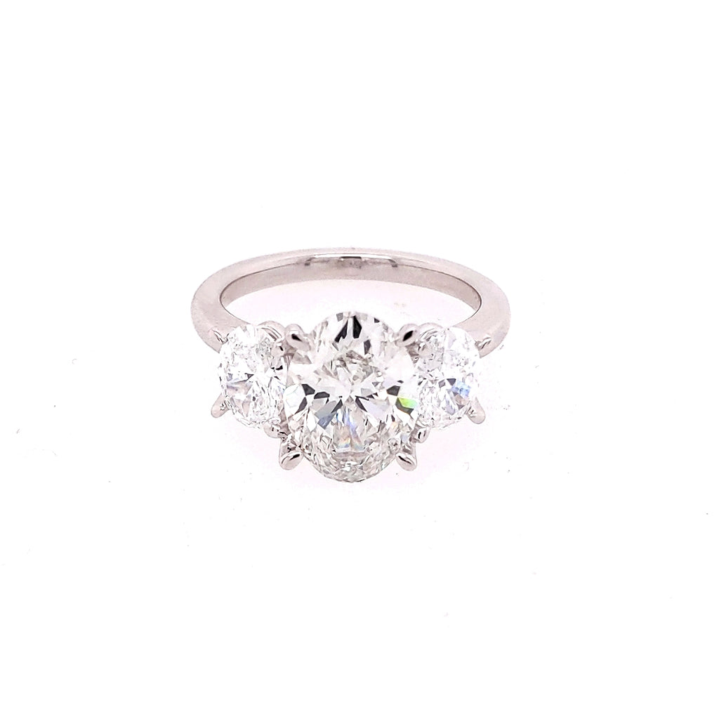 Three-stone oval diamond engagement ring.
