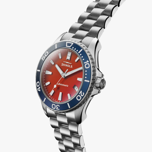 Stainless steel watch, red dial, blue bezel.