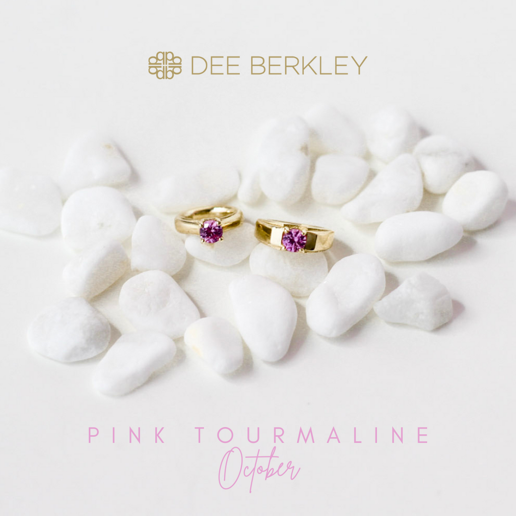 Gold rings with pink tourmaline on white stones.