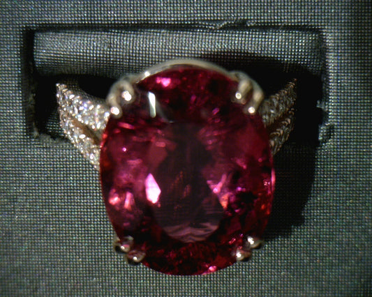 Oval Rubellite Tourmaline ring with diamond accents.