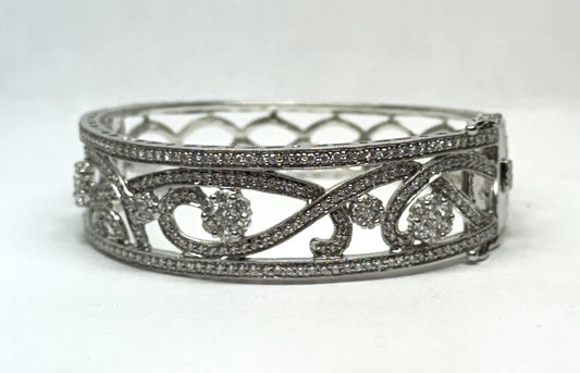 Intricate diamond bangle with swirling design.