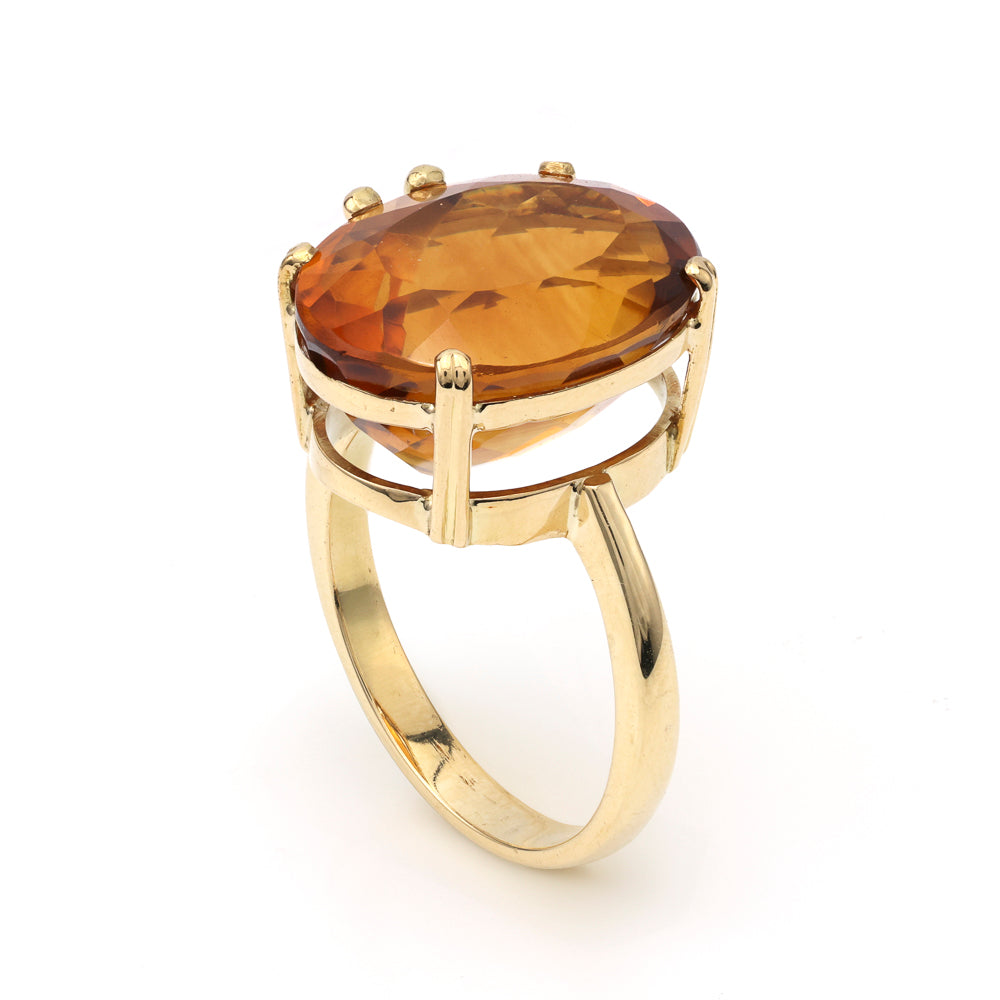Oval citrine ring in yellow gold setting.