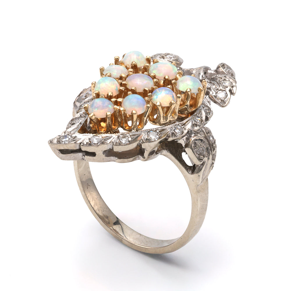 Opal and diamond ring in gold setting.