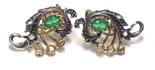 Two-tone earrings with green oval stones.