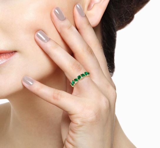 Emerald and diamond band in yellow gold.