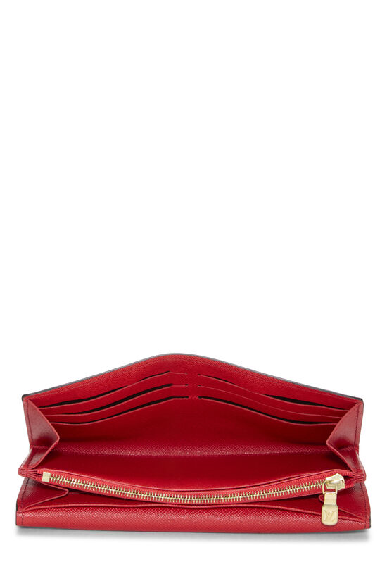 Red leather wallet with gold zipper.