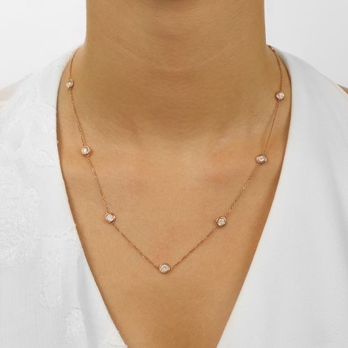 14K rose gold necklace with round diamonds.