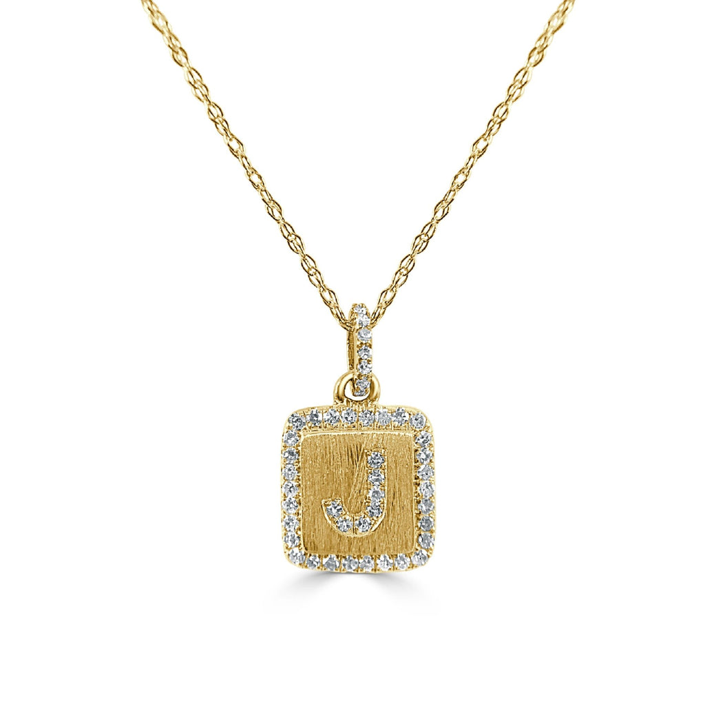 Gold initial pendant with diamond border.