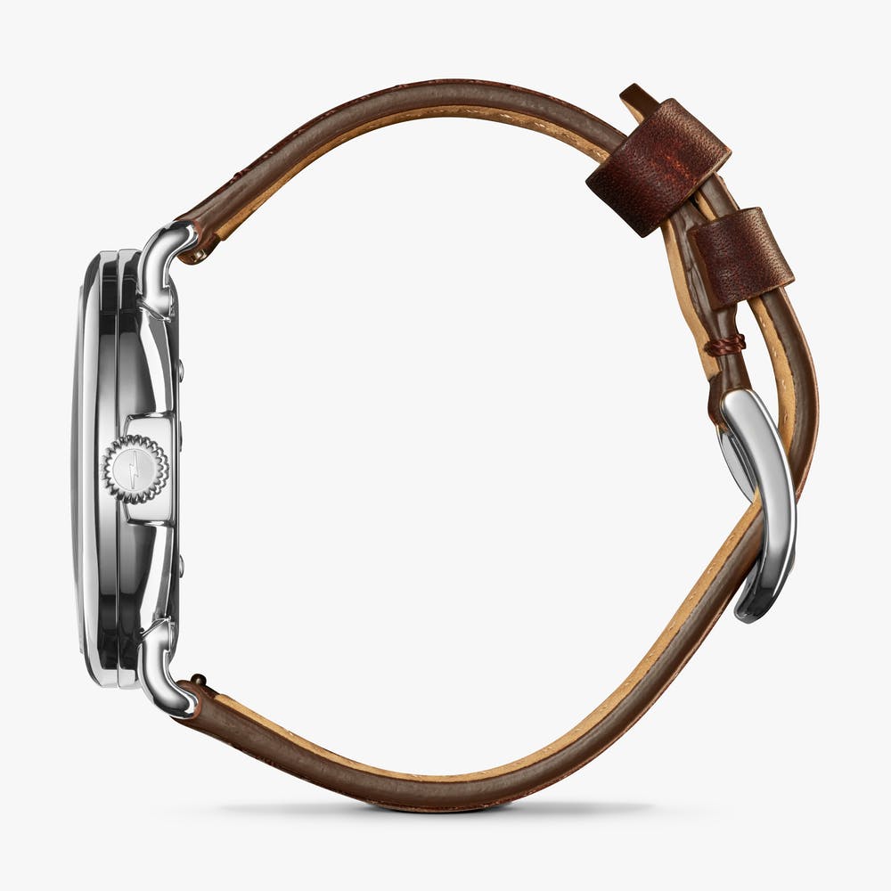 Silver watch with brown leather strap.