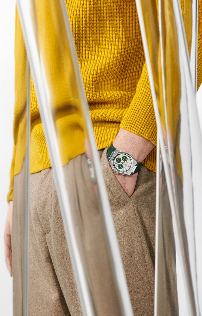 Green-dial watch with stainless steel case.