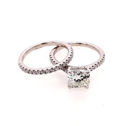 Cushion diamond engagement ring with accent stones.