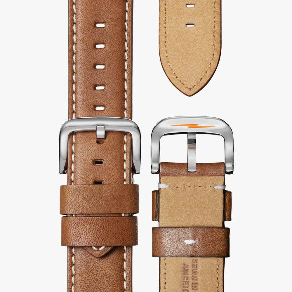 Brown leather watch strap with silver buckle.