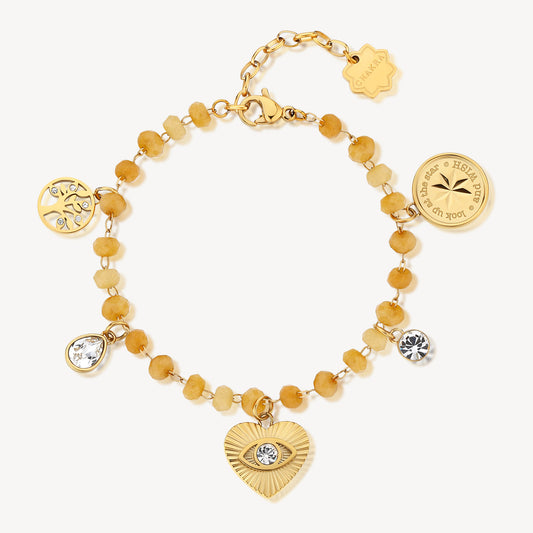 Yellow gemstone bracelet with heart and charms.