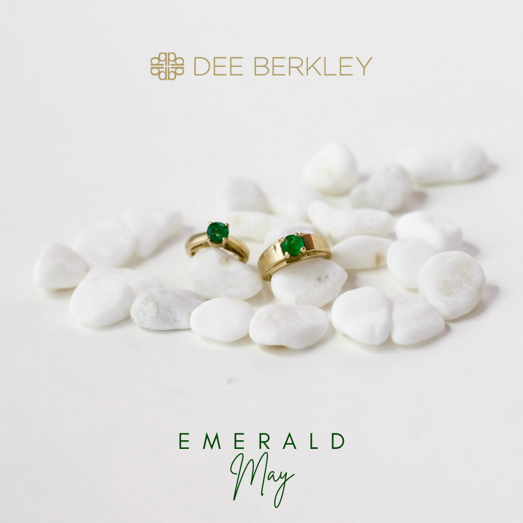 Emerald gold rings on white stones.