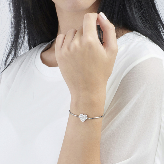 Heart-shaped simulated diamond bracelet on wrist.