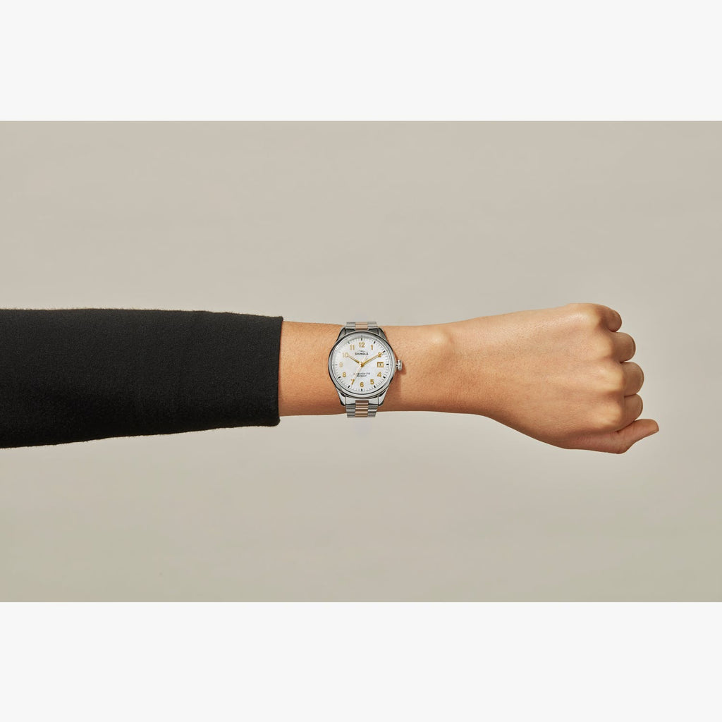 Stainless steel watch with mother of pearl dial.