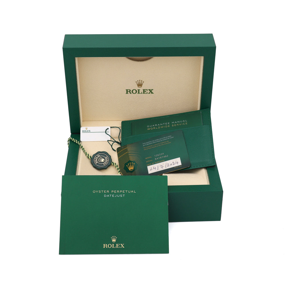 Green Rolex box with manuals and tag.