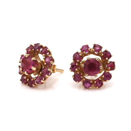 Round ruby earrings in yellow gold setting.
