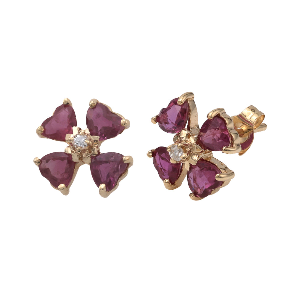 Heart-shaped ruby and diamond gold earrings.