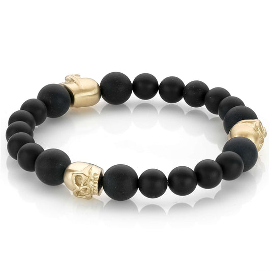 Black onyx bracelet with gold skulls.