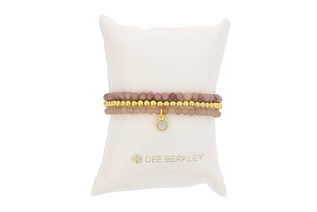 Pink moonstone bracelet with gold beads.