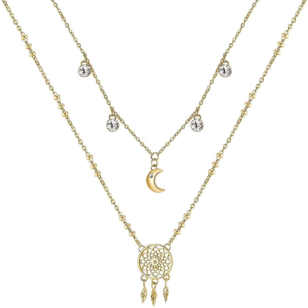 Layered gold necklace with moon and dreamcatcher.