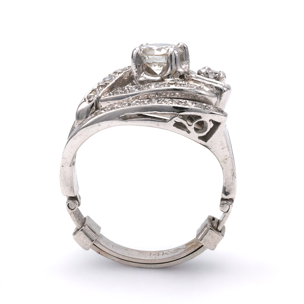 Platinum ring with round diamond centerpiece.