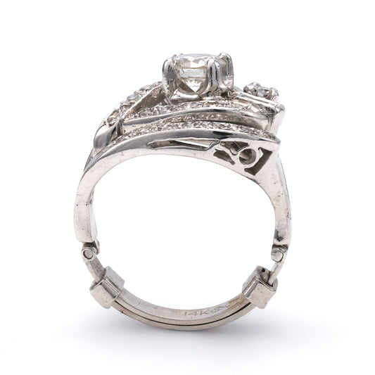 Platinum ring with round diamond centerpiece.