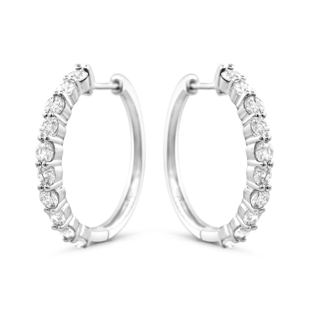 Sterling silver hoops with white sapphires.