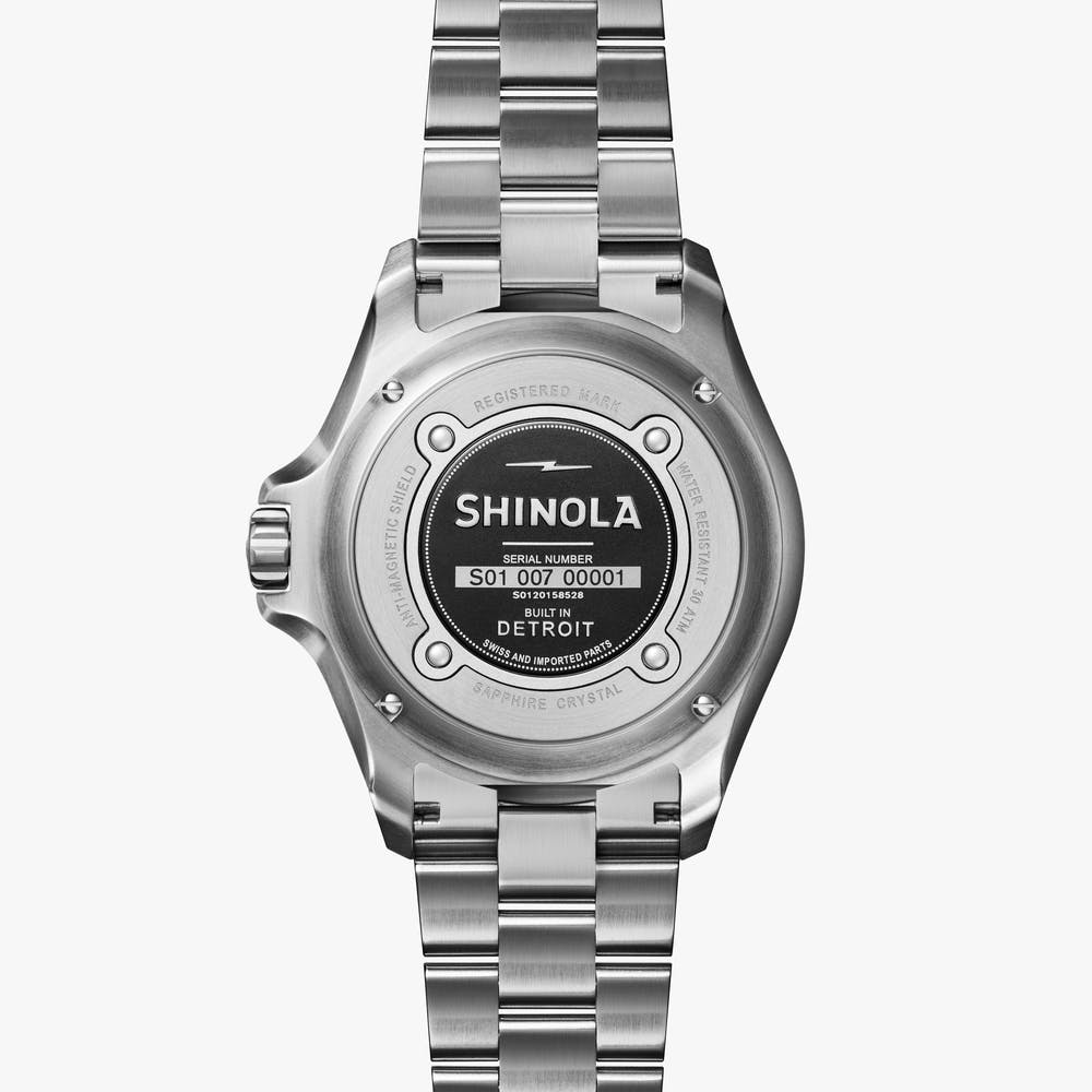 Stainless steel watch back with engraved details.