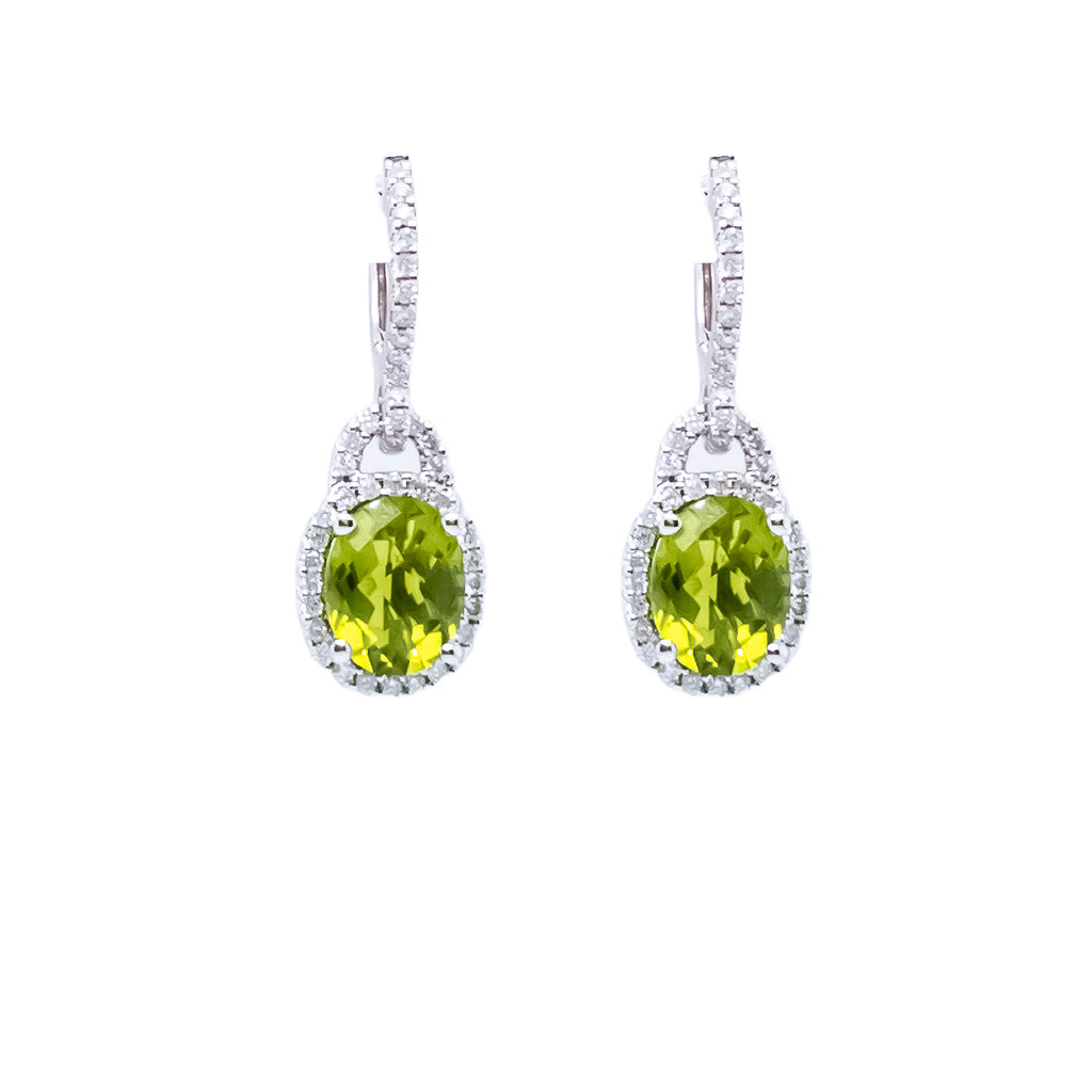 Dangle earrings with oval green gemstones.
