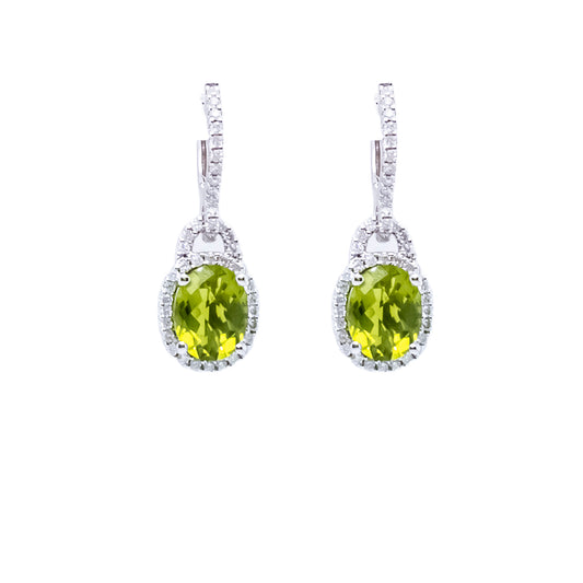 Dangle earrings with oval green gemstones.