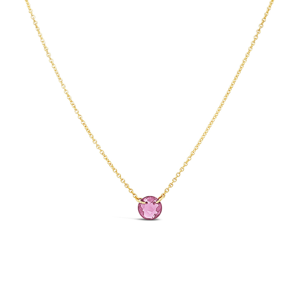 Gold necklace with round pink topaz pendant.