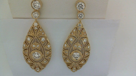 Gold drop earrings with round diamonds.