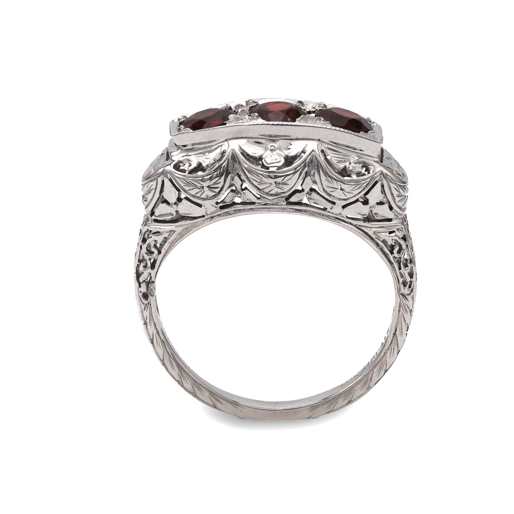 18K white gold ring with garnets.