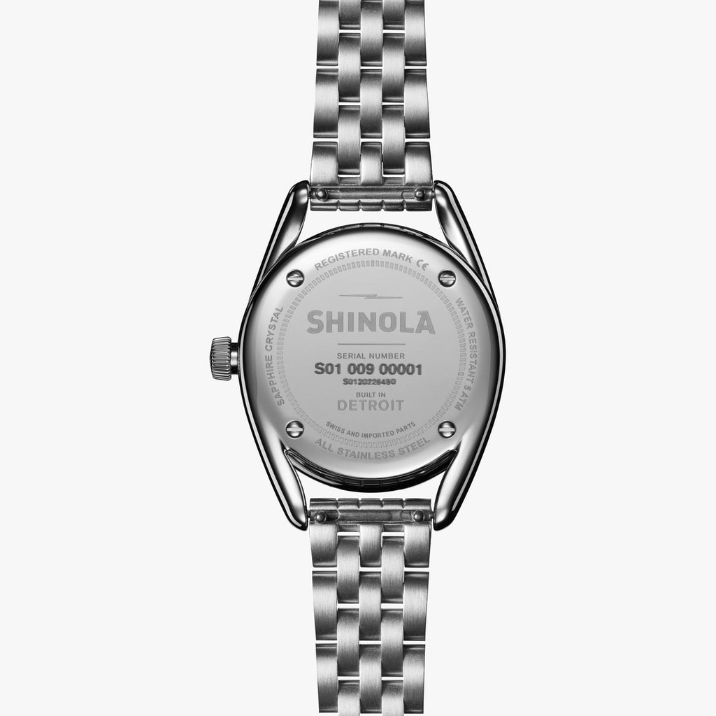 Stainless steel watch back with engraved details.