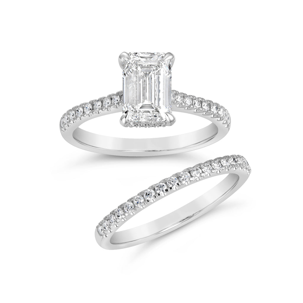 Emerald-cut diamond ring with side accents.