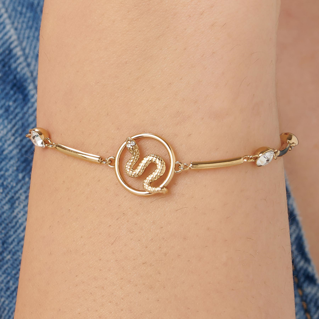 Gold-plated bracelet with snake design and crystals.