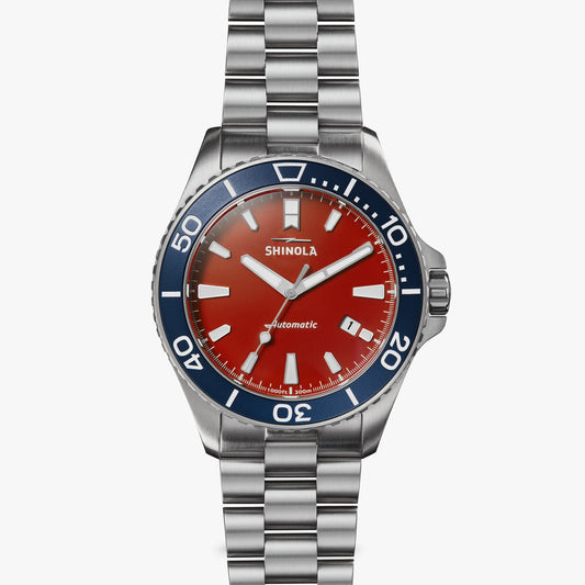 Stainless steel watch, red dial, blue bezel.