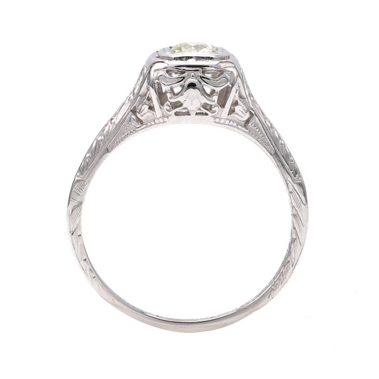 Vintage white gold ring with intricate detailing.