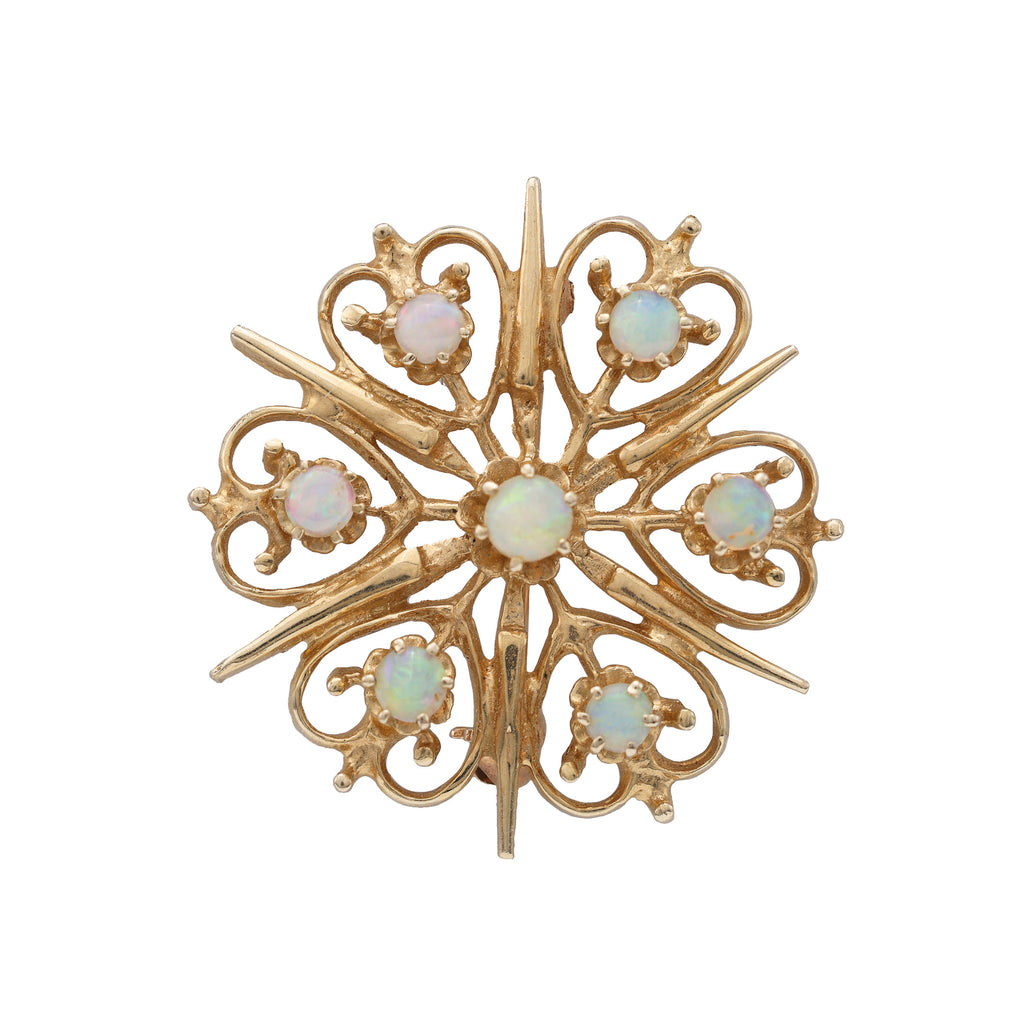 Starburst opal pin in yellow gold.