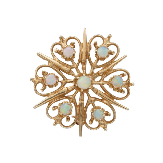 Starburst opal pin in yellow gold.