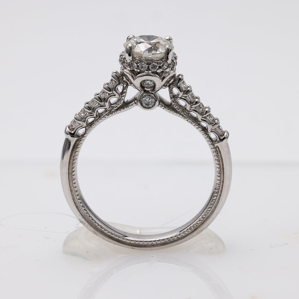 Vintage diamond engagement ring with intricate side stones.